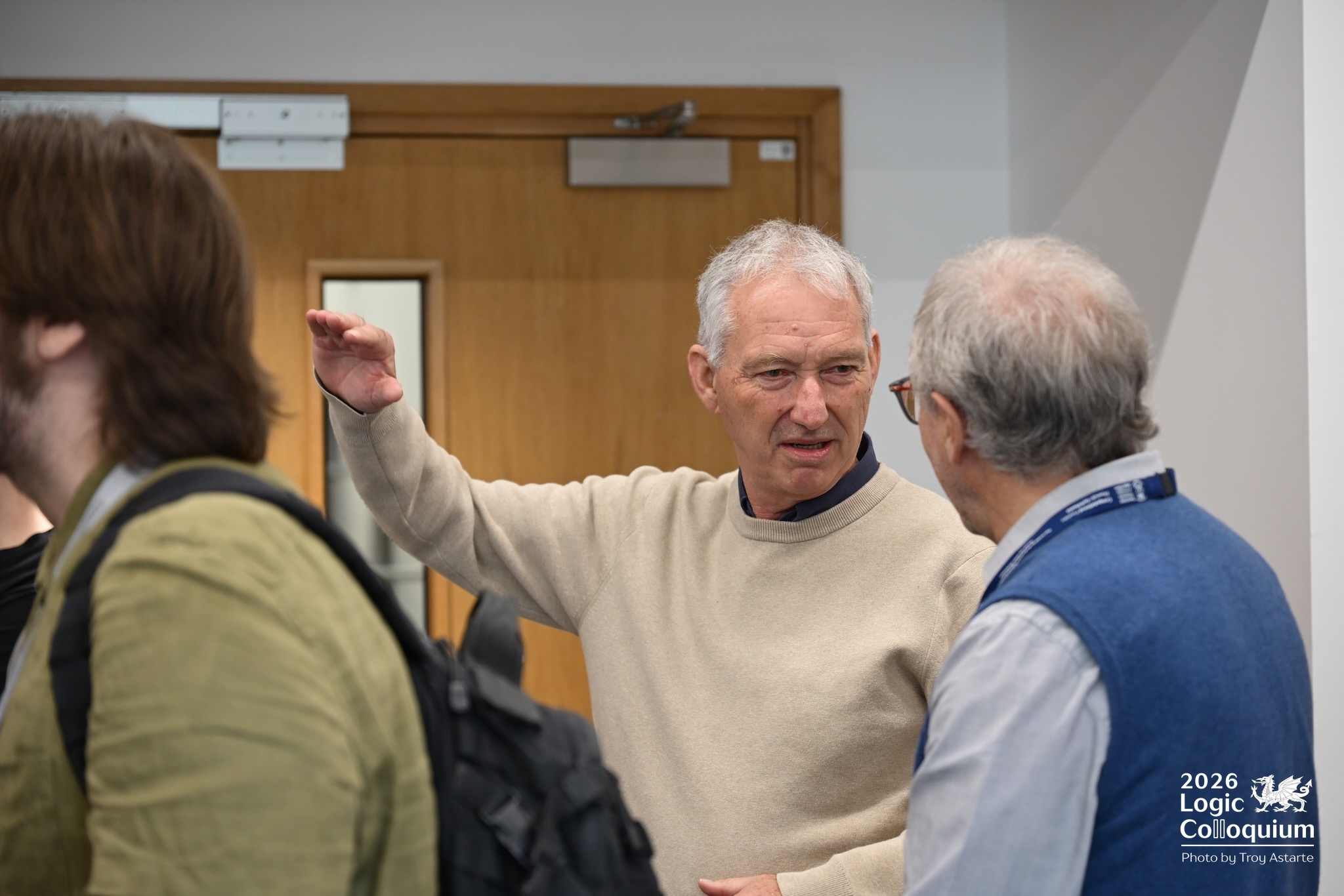 Photograph of a distinguished type gesticulating to help explain a point about logic.