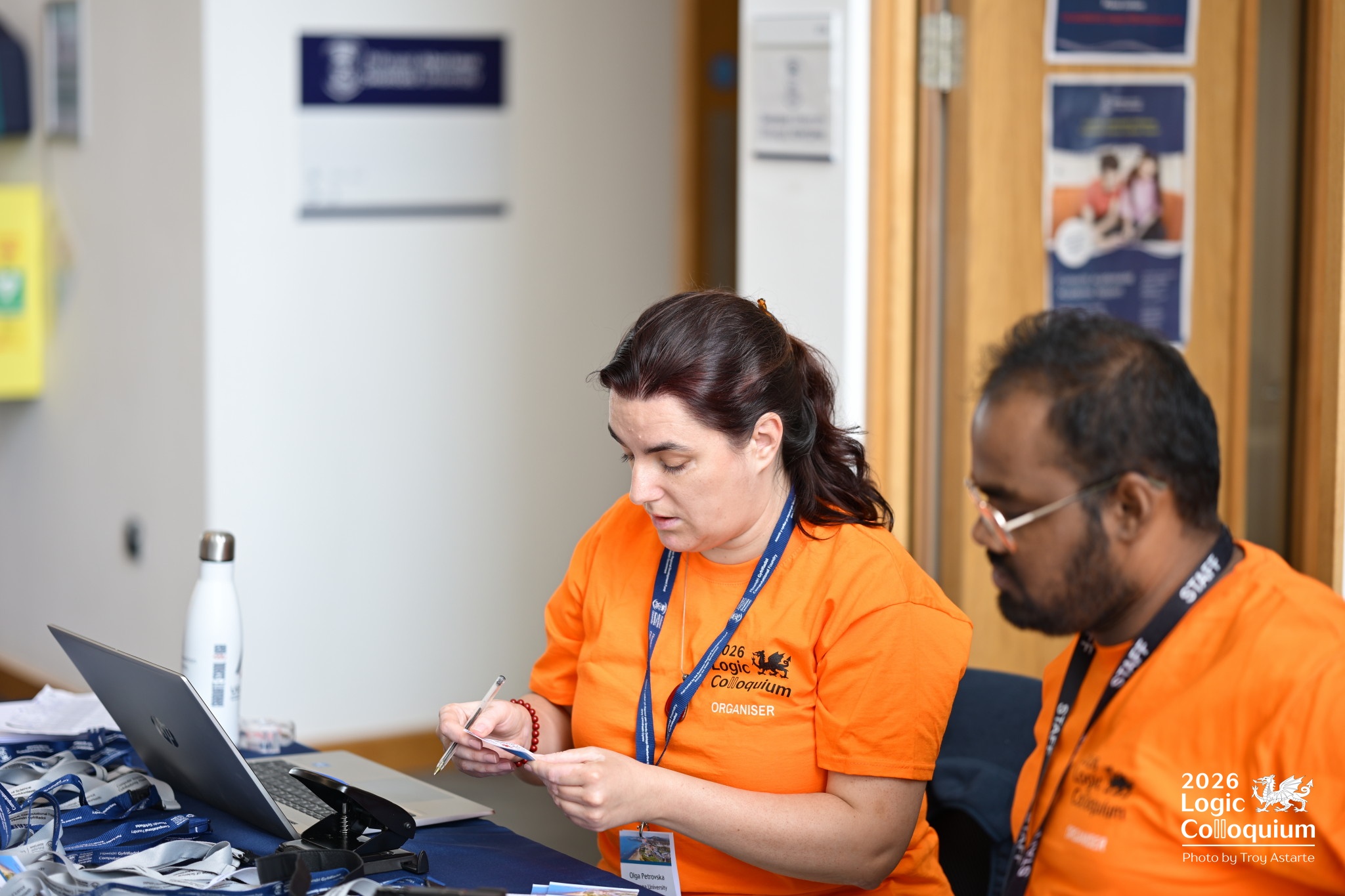 Photograph of two organisers in their distinctive attire looking stressed while sitting at a desk.