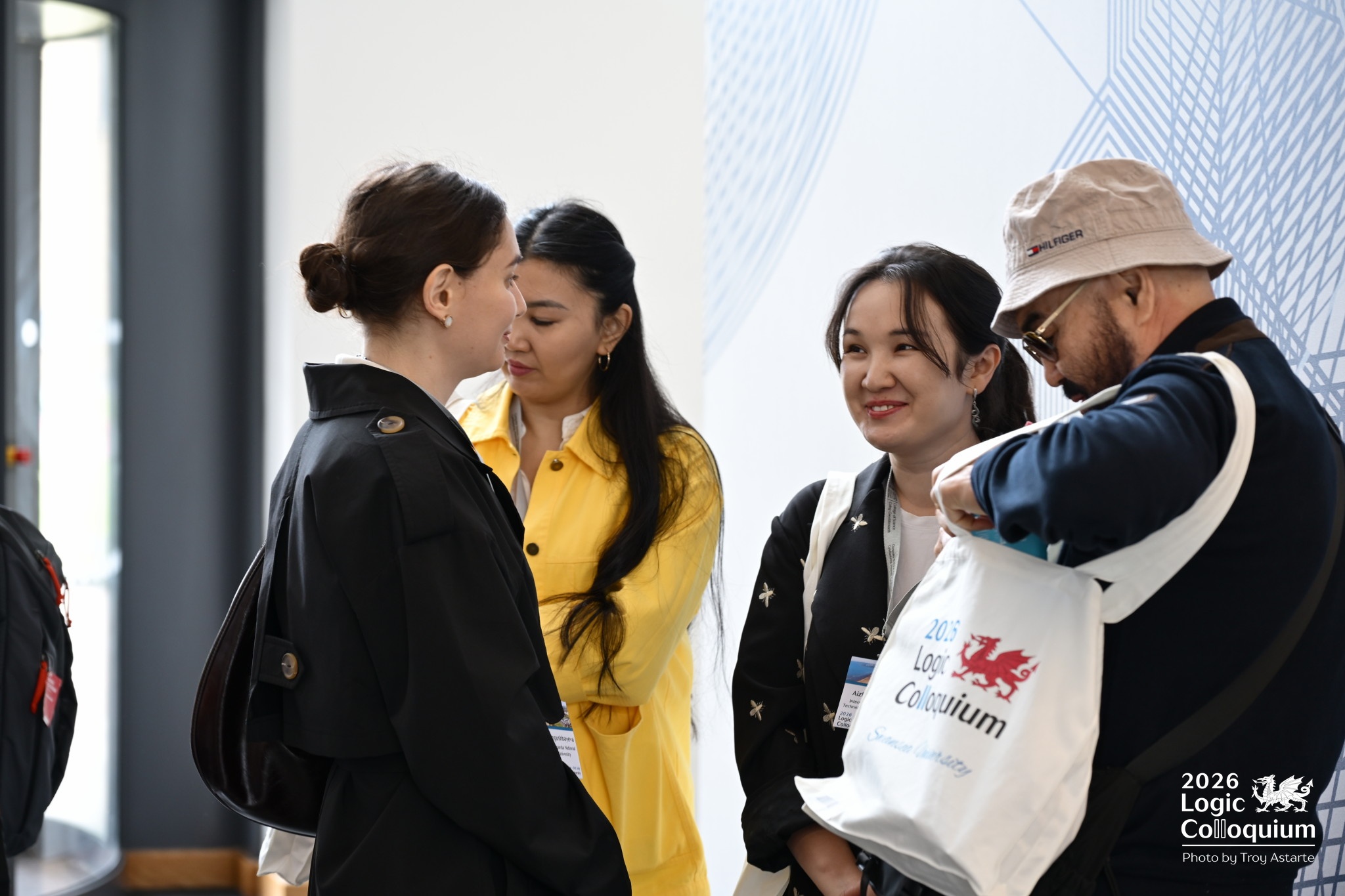 Photograph of conference goers excitedly exploring the contents of the official Conference Bag.