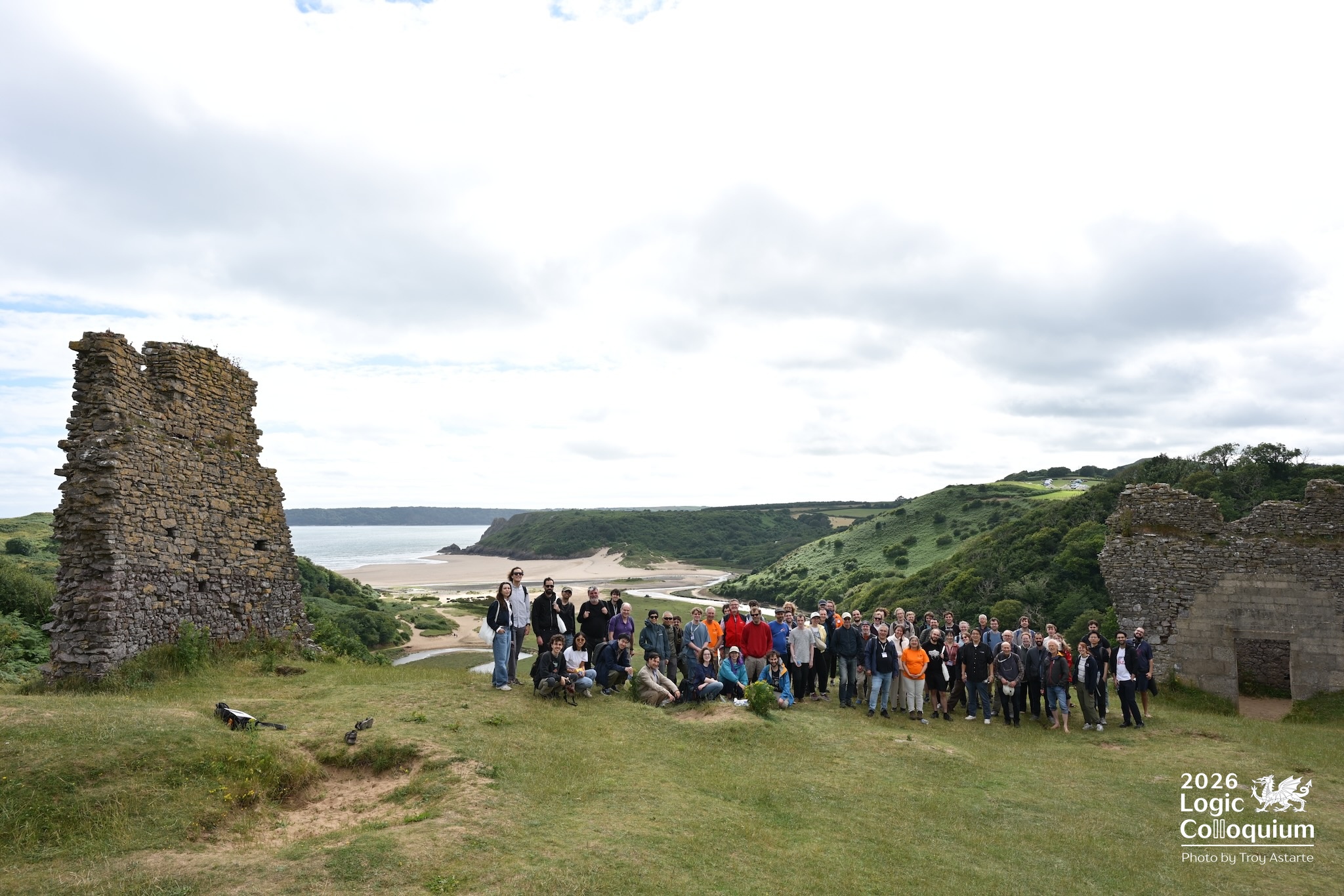 photograph of the walkers gathered among the ruins of Pennard Castle, with the Pill opening up behind them.